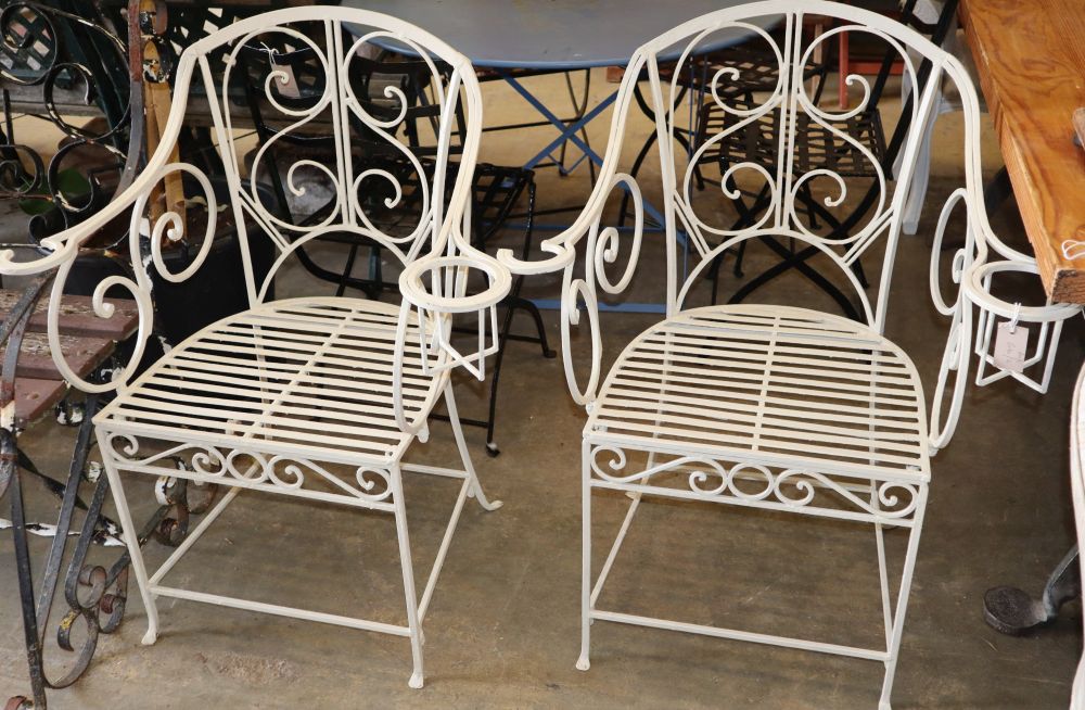A pair of painted metal garden chairs with cup holders